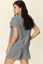 Woman in charcoal grey texture short sleeve top and drawstring shorts set