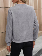 Gray textured sweatshirt with asymmetrical neck, ribbed cuffs, black pants