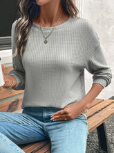 Gray waffle knit long sleeve top with moderate stretch for women
