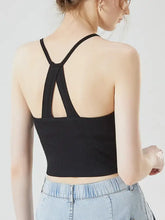 Black ribbed knit grecian neck cropped tank with chest pads showing crisscross back straps