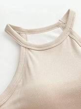 Beige ribbed knit grecian neck tank with chest pads featuring a halter top and cutout neckline design