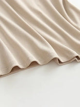 Beige ribbed knit grecian neck tank with chest pads featuring a soft textured weave and neatly finished hem