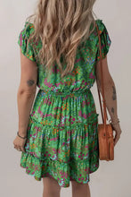 Green floral print tiered summer dress with ruffled sleeves, hem and woven bag