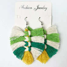 Green macrame leaf dangle earrings with tassels on soft cloth card