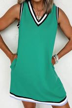 Green sleeveless dress with black and white trim, pocket detail, machine wash cold