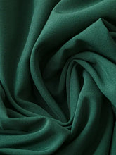 Deep green textured polyester dress with spaghetti straps and subtle sheen