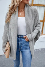 Gray long sleeve textured cardigan with high collar, ribbed cuffs, heart necklace