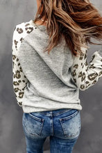 Women’s grey leopard print raglan sleeve top with blue skinny jeans