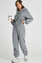 Grey oversized hoodie and jogger set in full length with white sneakers