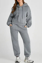 Grey full-length joggers with pockets and drawstring waistband
