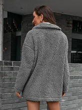 Grey teddy bear coat with hood, long sleeves, fur texture, and chain shoulder detail