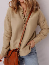 Beige long-sleeved grommet detail v neck sweatshirt with buttoned front and ribbed cuffs machine wash cold care instructions