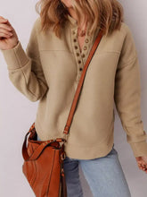 Tan leather crossbody bag with studded detailing and zipper closure shown with grommet detail v neck sweatshirt care instructions include machine wash cold