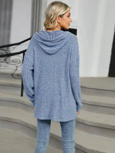 Woman in light blue half button long sleeve hooded top and jeans