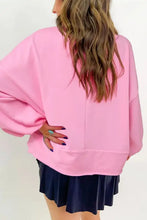 Pink oversized long sleeve sweatshirt with half button and ribbed hem