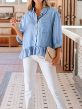 Light blue chambray shirt with half sleeves button down front and ruffled high low hem design