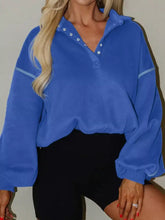 Blue oversized half snap dropped shoulder sweatshirt with silver button accents and light blue trim, machine wash cold