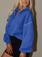 Blue half snap dropped shoulder sweatshirt with silver buttons and light blue piping machine wash cold recommended