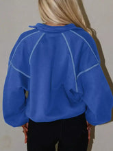 Blue half snap dropped shoulder sweatshirt with light blue stitched paneling suitable for machine wash cold
