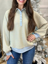 Half snap long sleeve sweatshirt in pale yellow ribbed knit with subtle stripes and light blue button accents