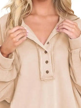 Beige oversized half snap long sleeve sweatshirt with button-front closure and ribbed cuffs machine wash tumble dry care instructions