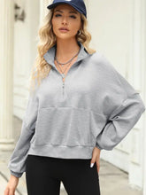 Light gray half-zip collared sweatshirt with long sleeve length