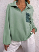 Half zip dropped shoulder sweatshirt in soft mint green fleece with dark teal pocket designed for best fit and machine wash