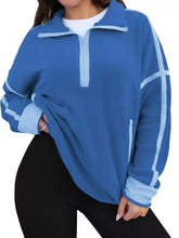 Blue fleece half zip dropped shoulder sweatshirt with light blue contrast stitching along sleeves and zipper, machine wash