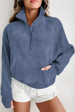 Dusty blue half zip long sleeve sweatshirt with high collar and thumbholes