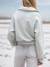 Light gray textured half zip long sleeve sweatshirt with raglan sleeves