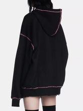 Black oversized halloween zip-up drawstring hoodie with pink glittery trim made of slightly stretchy material