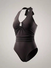 Black halter neck bodysuit with ruched bodice and oval ring detail at neckline perfect for stylish swimwear looks