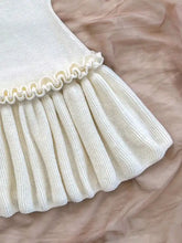 Cream-colored ribbed halter neck ruffle hem knit sweater dress