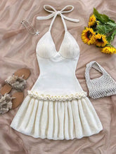 Off-white ribbed knit halter dress with ruffled hem and tied neck ties
