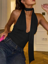 Black halter neck tie cami with deep v cut and flowing fabric featuring a neck tie detail