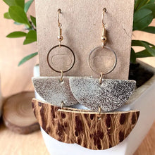 Gray speckled semicircle drop earrings with gold accents and leather