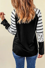 Black long-sleeve top with white striped leopard print sleeves and happy halloween graphic