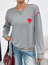 Heart embroidered round neck gray sweatshirt with red heart patch and trim made of slightly stretchy material
