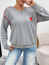 Gray heathered heart embroidered round neck sweatshirt with red trim made of slightly stretchy material