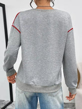 Gray heathered heart embroidered round neck sweatshirt with red shoulder trim made of slightly stretchy material