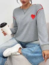 Gray heart embroidered round neck sweatshirt with red trim and slightly stretchy material for comfortable wear