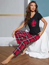 Black v-neck top with short sleeve length and red black plaid heart patch paired with matching plaid pants lounge set