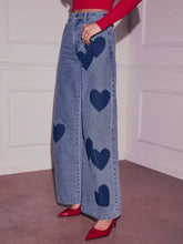 Light-wash denim heart high waist wide leg jeans with dark blue heart patches for a stylish casual look