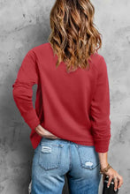 Red heart pearl round neck sweatshirt with long sleeve length and ripped blue jeans