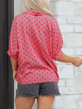 Pink heart print button-down shirt with subtle vertical stripes and rolled-up three-quarter sleeves