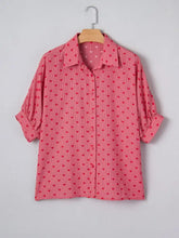 Pink heart print button shirt with subtle stripes displayed on wooden hanger for casual wear
