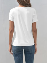 Back view of woman in heart round neck short sleeve t-shirt and jeans