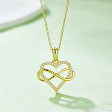 Gold heart-shaped pendant with infinity symbol and diamonds