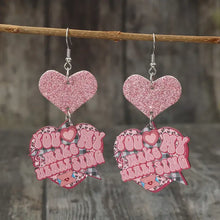 Pair of pink glitter heart shape wooden earrings with You Make My Heart Sing design