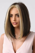 Heat safe dark brown bob wig with blonde highlights on model in pink top